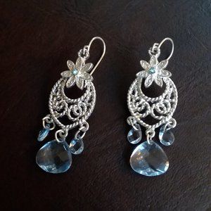 Silver filigree with rhinestone-centered flower, blue beveled beads, pierced ear